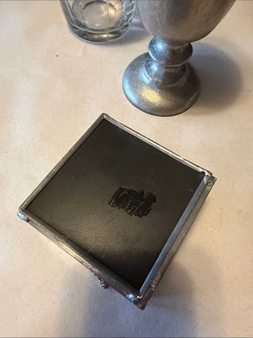 Vintage trinket box with metal edges and dried flowers on top. Mirror bottom.